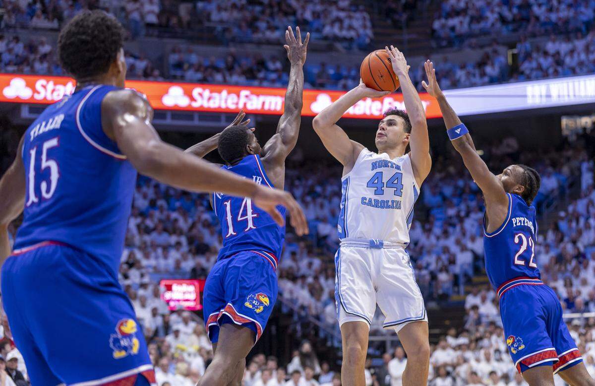 Kansas guard Melvin Council Jr. (14) and guard Darryn Peterson (22) defend North Carolina guard Luka Bogavac (44) in the first half on Friday, November 7, 2025 at the Smith Center in Chapel Hill, N.C.