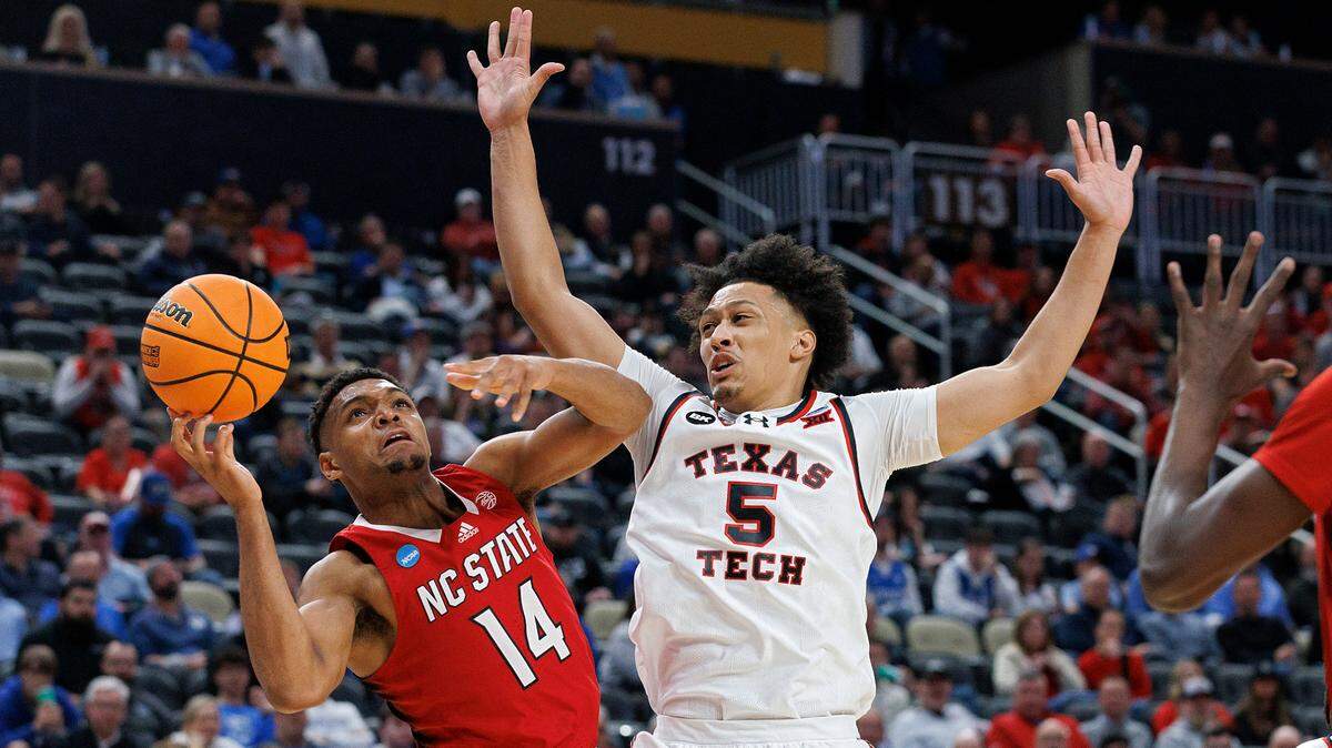 N.C. State’s Casey Morsell drives to the basket past Texas Tech’s Darrion Williams during the first half of the Wolfpack’s first round NCAA Tournament game on Thursday, March 21, 2024, at PPG Paints Arena in Pittsburgh, Pa.