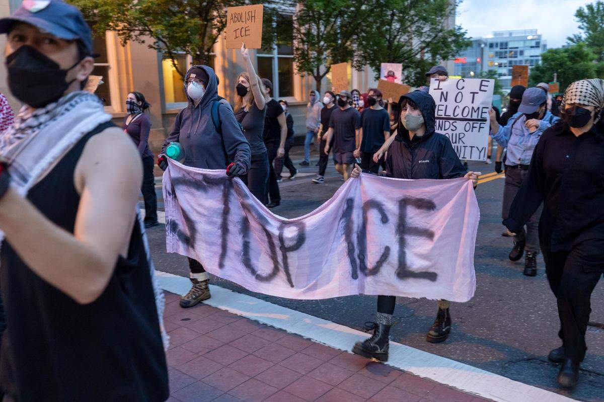 Part of the approximately 100 demonstrators rally as they march through downtown Durham calling for immigration reform on Friday, June 13, 2025 in Durham, N.C.