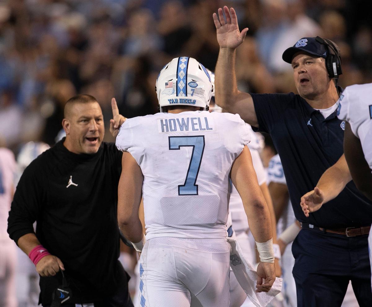 Offensive coordinator Phil Longo and offensive line coach Stacy Searels greet quarterback Sam Howell after leading the Tar Heels to a touchdown and a two point conversion in the second half against Wake Forest on Friday, September 13, 2019 at BB&T Field in Winston-Salem, N.C.