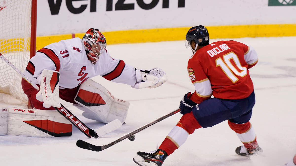 Florida Panthers left wing Anthony Duclair (10) makes a shot on goal as Carolina Hurricanes goaltender Frederik Andersen (31) defends the net during the first period at an NHL hockey game, Saturday, Nov. 6, 2021, in Sunrise, Fla. (AP Photo/Marta Lavandier)