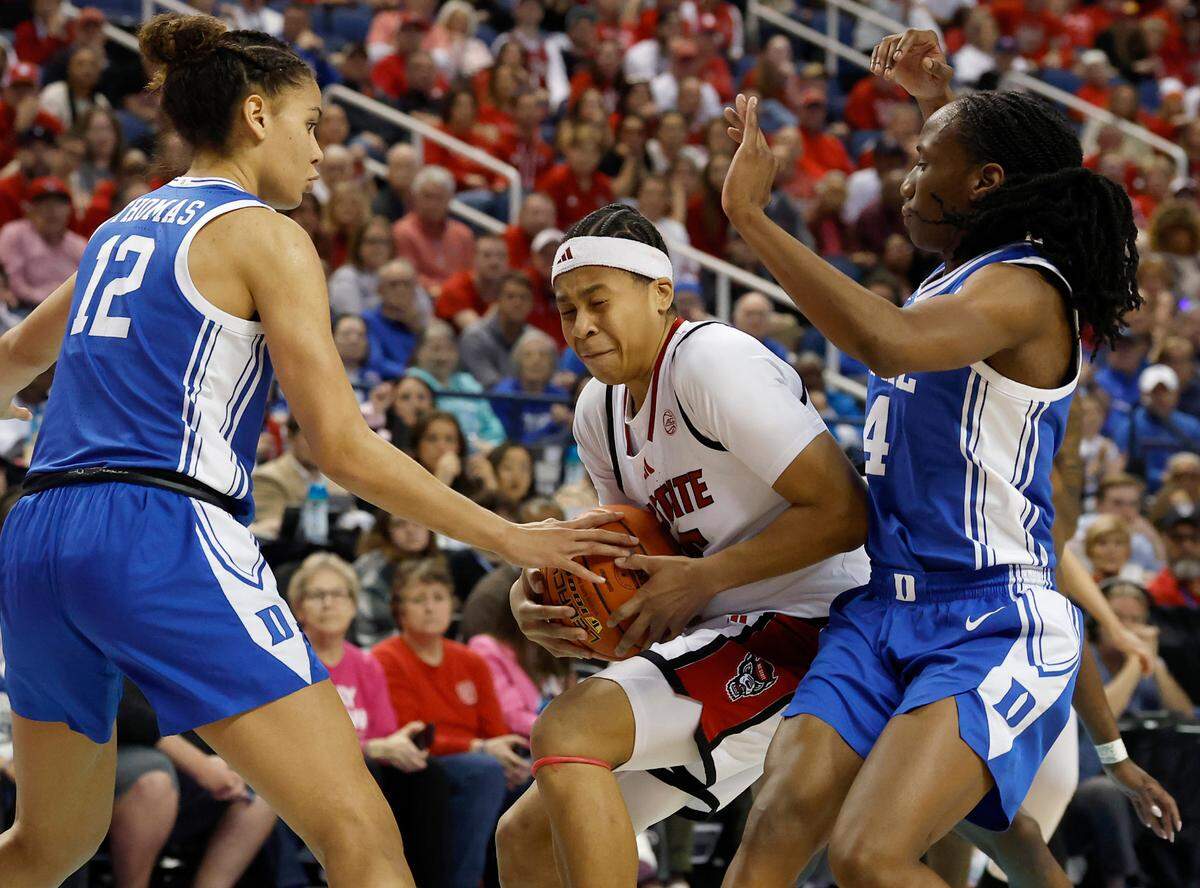 N.C. State’s Zoe Brooks drives between Duke’s Delaney Thomas and Jadyn Donovan during the second half of the Wolfpack’s 76-62 loss in the ACC Tournament final on Sunday, March 9, 2025, at First Horizon Coliseum in Greensboro, N.C.