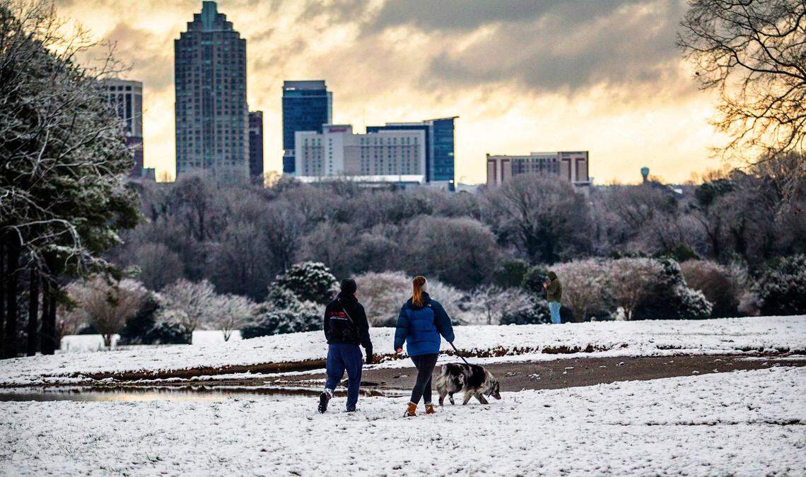Lewis Gaffney and Katie Gilmore walk Bode, an Australian Shepherd, at Raleigh’s Dorothea Dix Park in 2021.
