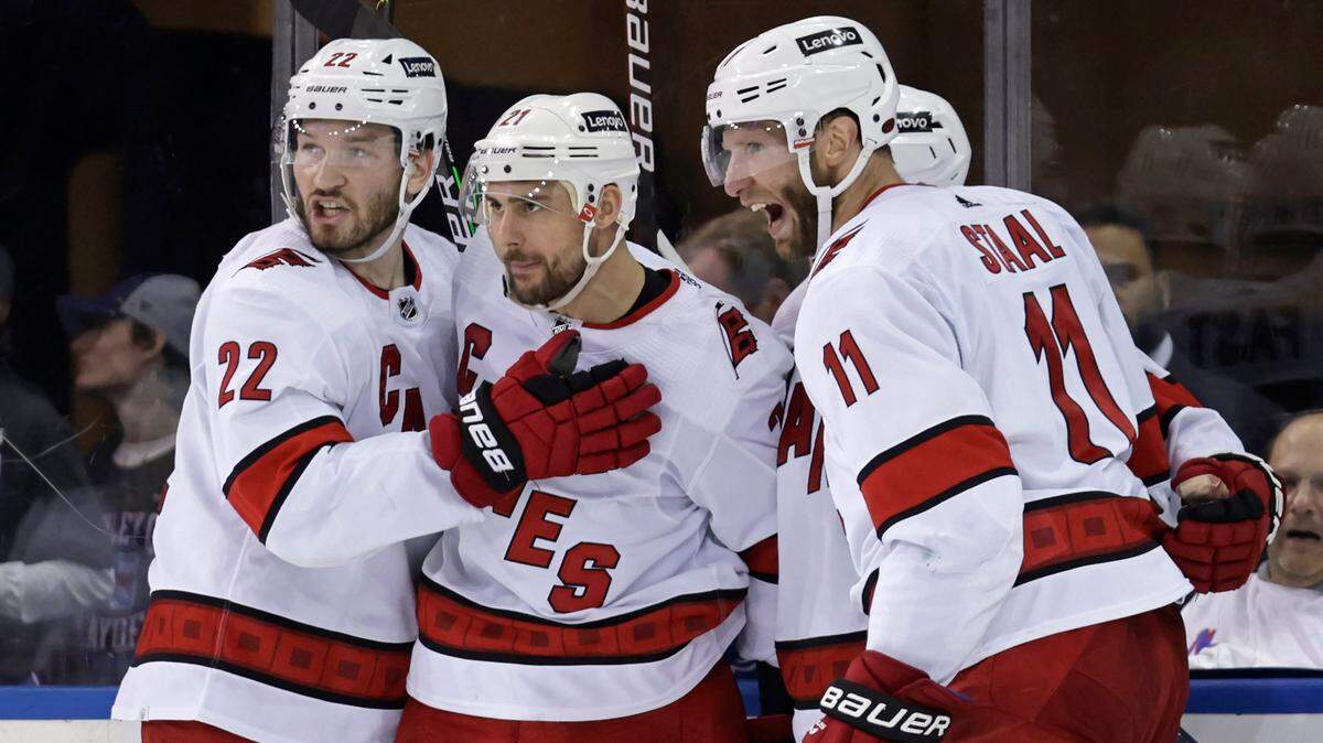 Carolina Hurricanes right wing Nino Niederreiter (21) is congratulated by teammates after scoring a goal against the New York Rangers during the second period of Game 3 of an NHL hockey Stanley Cup second-round playoff series, Sunday, May 22, 2022, in New York. (AP Photo/Adam Hunger)
