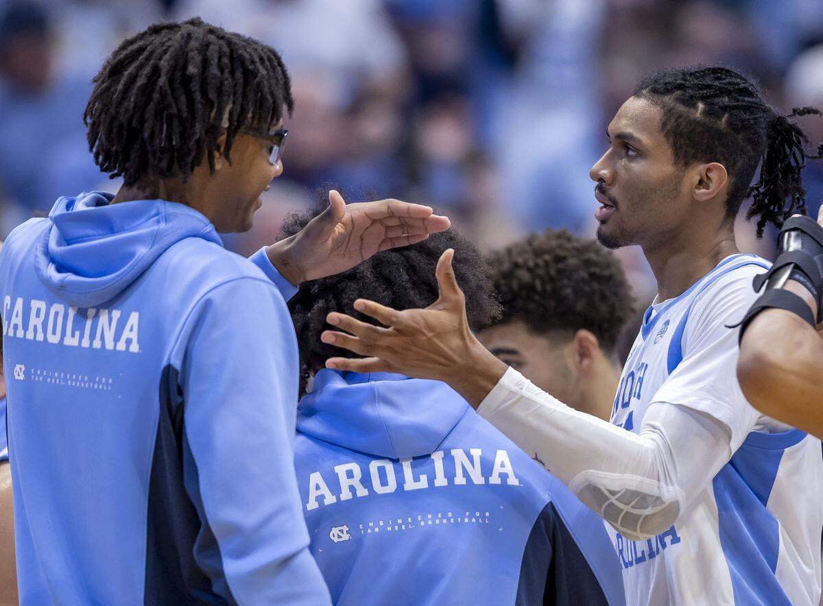 North Carolina forward Jarin Stevenson (15) is greeted by teammate James Brown after sinking a 3-point basket in the second half against Georgetown on Sunday, December 7, 2025 at the Smith Center in Chapel Hill, N.C.