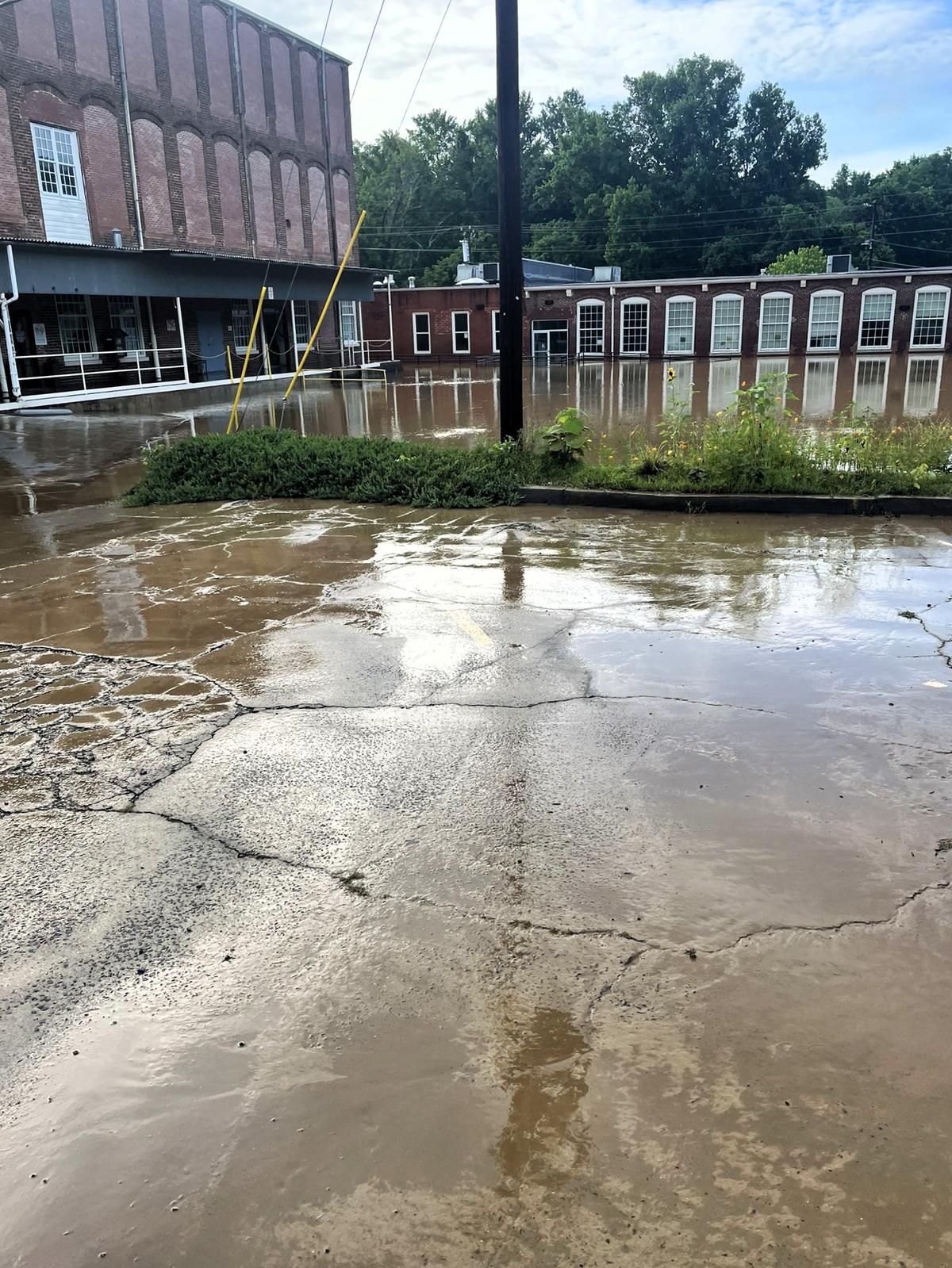 Floodwater was still 10 feet deep or more in the parking lot outside the Orange County Arts Commission, Eno Arts Mill and The Expedition School on July 7, 2025, the day after Tropical Storm Chantal dropped several inches of water in Hillsborough, NC.