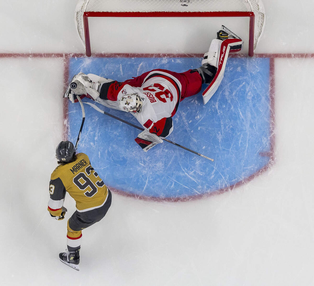 Carolina Hurricanes goalie Brandon Bussi (32) makes a glove save on a scoring attempt by Vegas right wing Mitch Marner (93) in the third period during Game 3 of the Stanley Cup Final, on Saturday, June 6, 2026 at T-Mobile Arena in Las Vegas, NV. Bussi started the third period replacing starter Frederik Andersen.