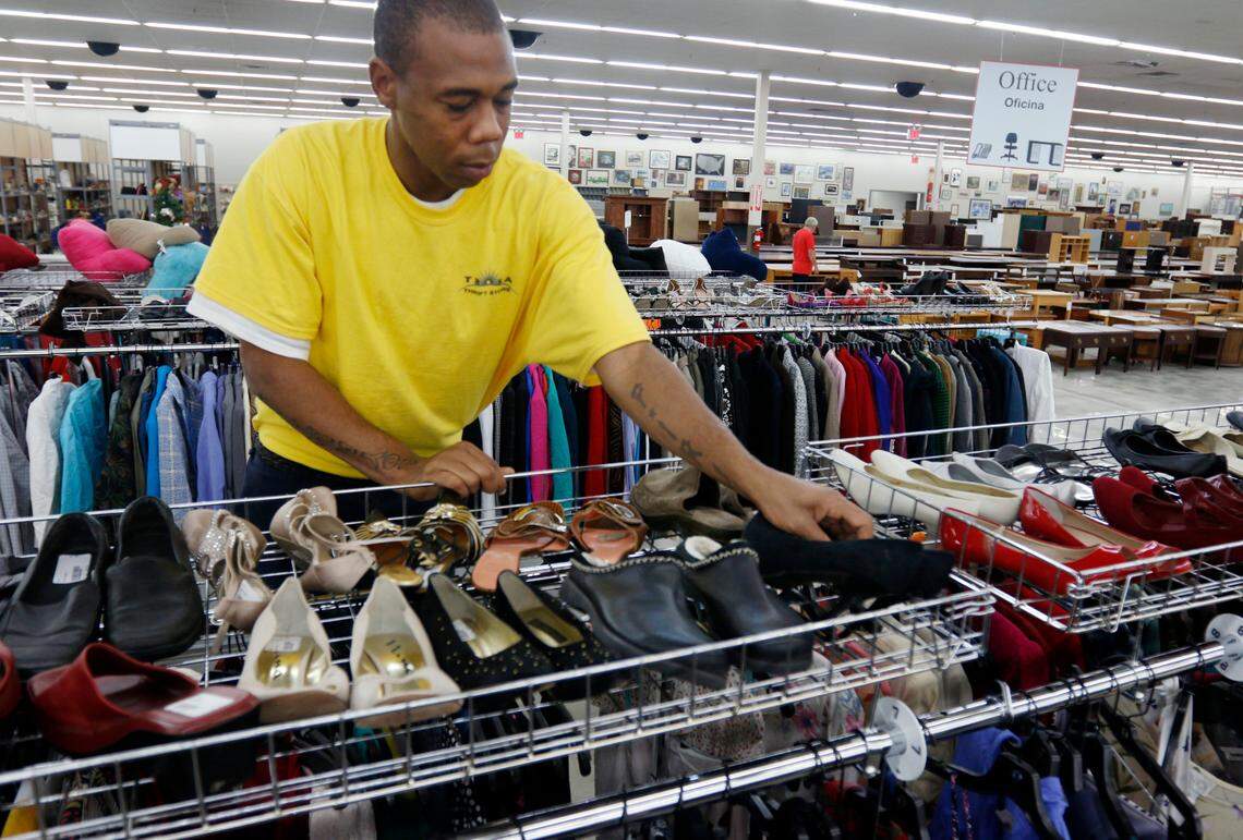 TROSA resident Curtis Lee matches donated shoes on the floor of the TROSA Thrift Store in Durham, in this News & Observer file photo taken Nov. 6, 2014.