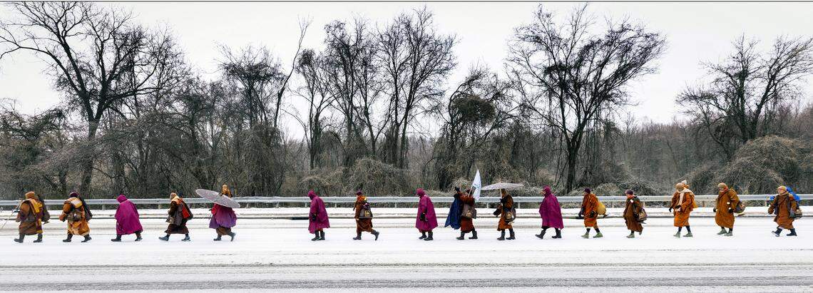 A procession of Buddhist monks walks along snow-covered Raleigh Boulevard in Raleigh on Sunday morning, Jan. 25, 2026. The monks are making a 2,300-mile pilgrimage from Texas to Washington, D.C., as part of the Walk for Peace, an effort to promote peace, compassion and national unity.