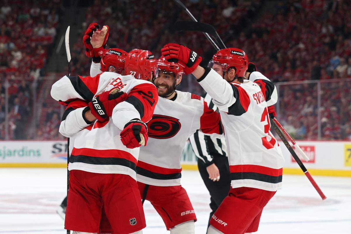 Sebastian Aho of the Carolina Hurricanes is mobbed by teammates after scoring a goal against the Montreal Canadiens during the first period in Game 4 of the Eastern Conference Final of the 2026 Stanley Cup Playoffs at Bell Centre on May 27, 2026 in Montreal, Quebec, Canada.