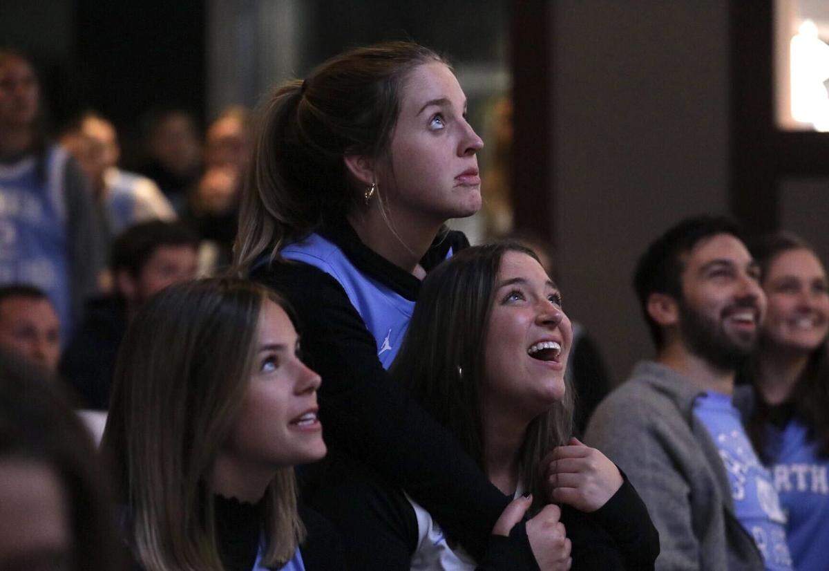 Emily Holler leans on her friend and fellow UNC alum Avery Snoddy while watching the start of the historic Final Four game between UNC and Duke at Top of the Hill Restaurant and Brewery in Chapel Hill on Saturday.