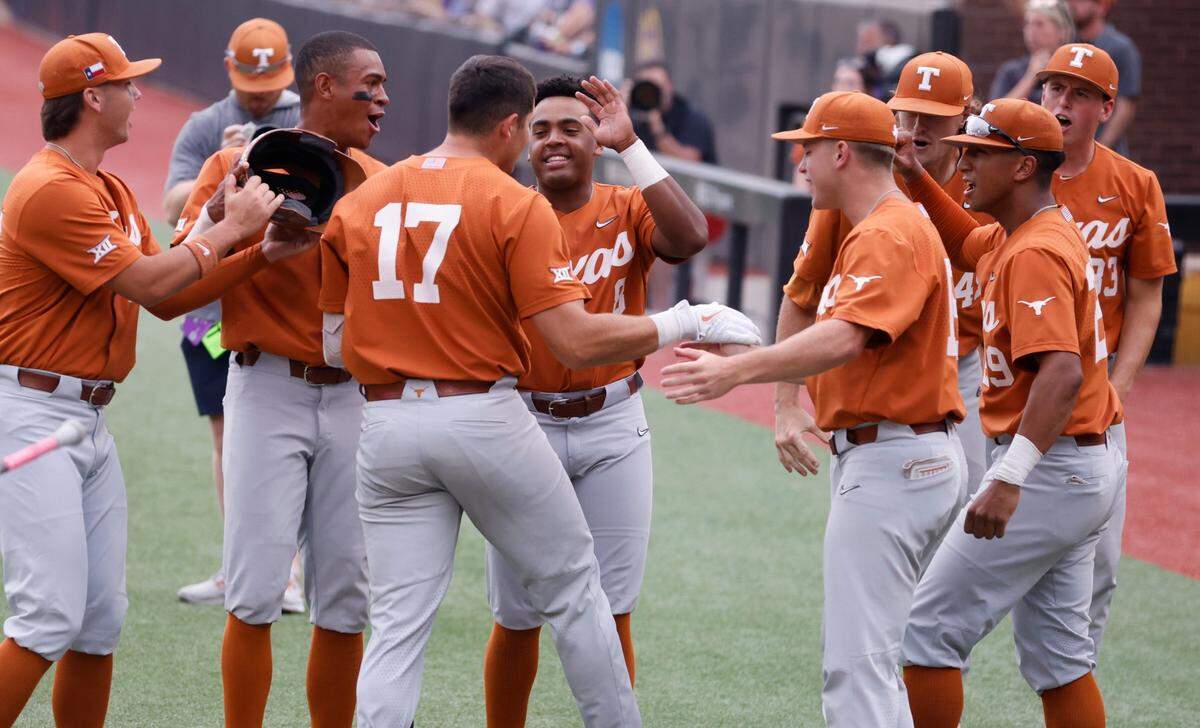 Texas Ivan Melendez (17) is congratulated by teammates after hitting a three-run homerun in the first inning during ECUs game against Texas in the Greenville Super Regional at Clark-LeClair Stadium Sunday, June 12, 2022.