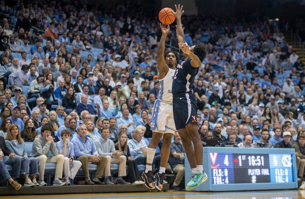 North Carolina’s Caleb Love (2) puts up a shot against Virginia’s Reece Beekman (2) in the first half against Virginia on Saturday, February 25, 2023 at the Smith Center in Chapel Hill, N.C.