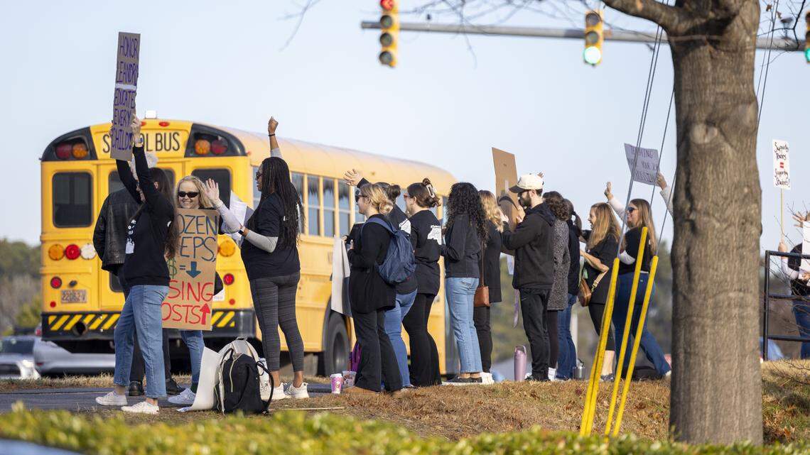 Dozens of educators demonstrate at the intersection of Green Level Church Road and Carpenter Fire Station Road in Cary on Wednesday morning, Jan. 7, 2026, calling on state lawmakers to provide more funding for public education. Leaders of NC Teachers in Action say 650 to 750 educators from 52 schools, including 30 in Wake County, called out of work Wednesday to participate in the protests.