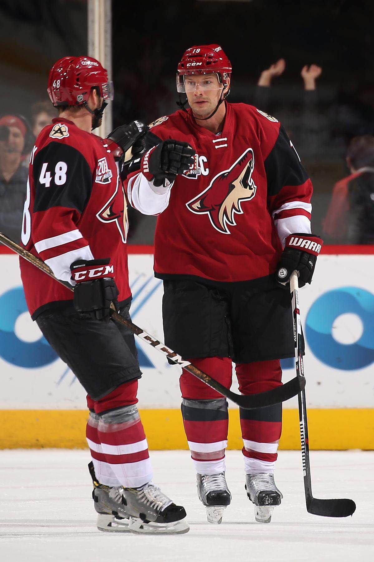 Shane Doan, right, of the Arizona Coyotes celebrates with Jordan Martinook after scoring a goal against San Jose Sharks during the third period of the preseason NHL game at Gila River Arena on October 7, 2016 in Glendale, Arizona.