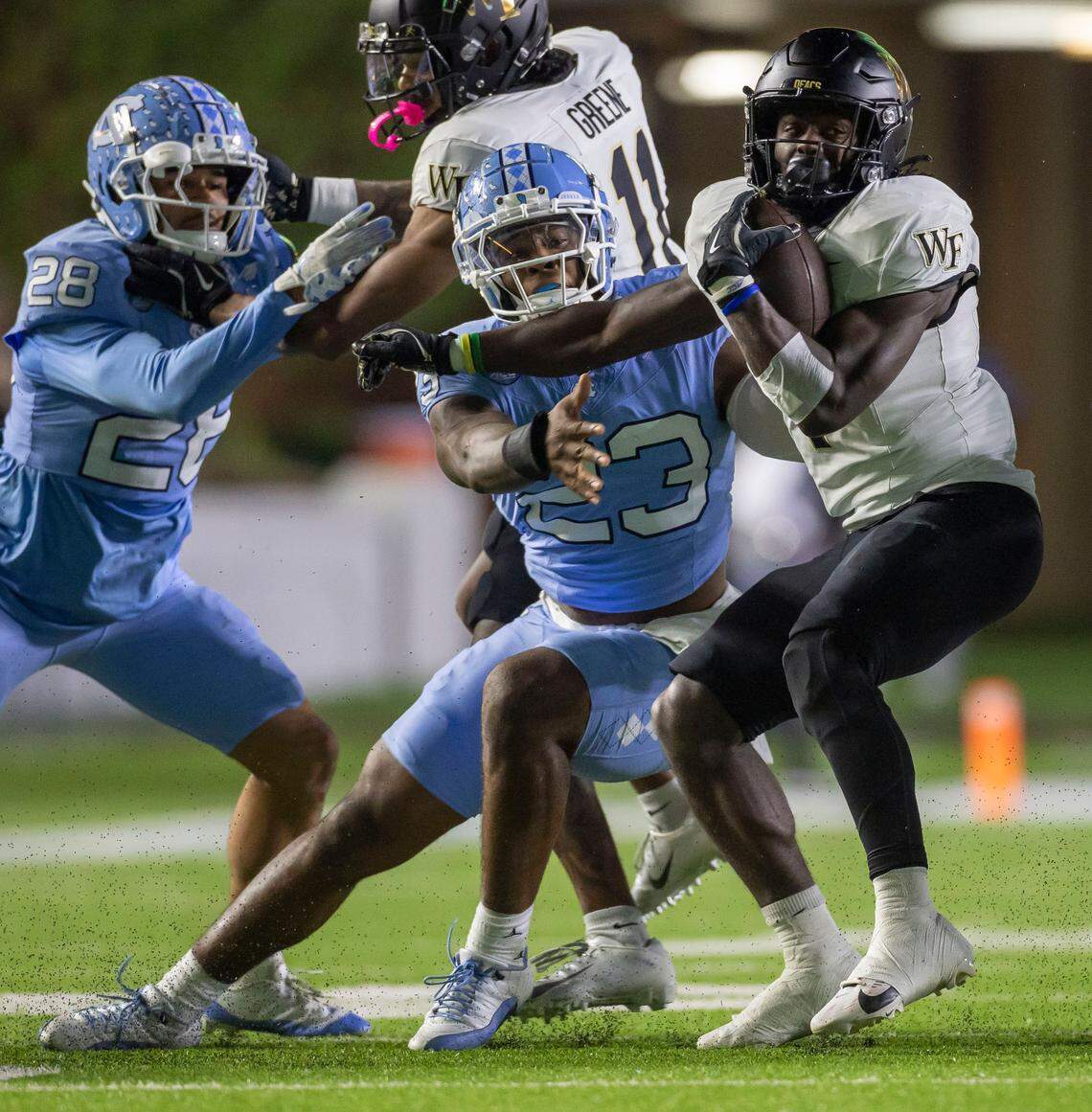 North Carolina linebacker Power Echols (23) stops Wake Forest running back Demond Claiborne (1) after a two-yard gain in the first quarter on Saturday, November 16, 2024 at Kenan Stadium in Chapel Hill, N.C.