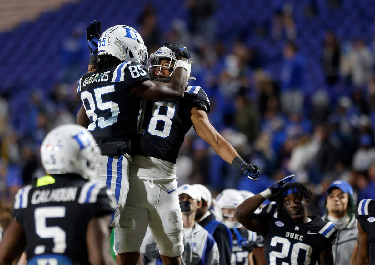 Duke’s Sahmir Hagans celebrates with Malik Bowen-Sims after scoring a touchdown to give the Blue Devils the lead over Wake Forest during the second half of Duke’s final regular season game at Wallace Wade Stadium on Saturday, Nov. 26, 2022, in Durham, N.C.