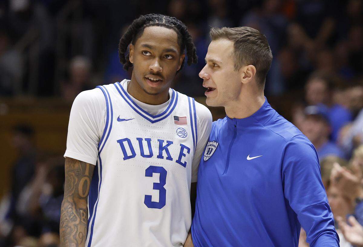 Duke head coach Jon Scheyer talks with Isaiah Evans (3) late in the second half of Duke’s 77-51 victory over Virginia at Cameron Indoor Stadium in Durham, N.C., Saturday, Feb. 28, 2026.