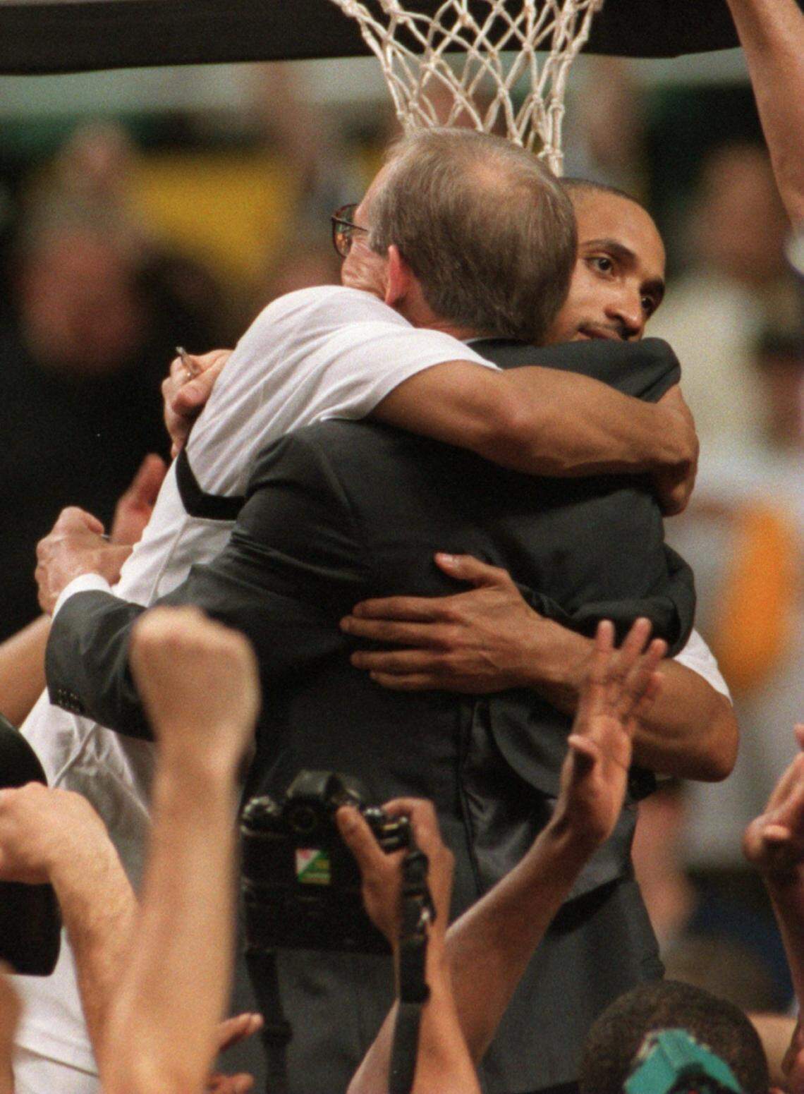 Randolph Childress and Dave Odom embrace before cutting down the net after Wake Forest won the 1995 ACC Tournament in Greensboro.