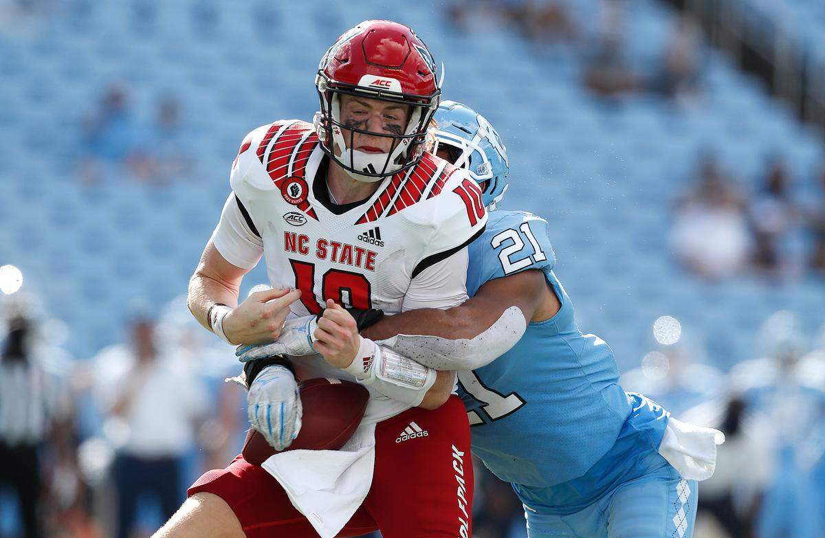 North Carolina linebacker Chazz Surratt (21) forces N.C. State quarterback Ben Finley (10) to fumble the ball during the second half of UNC’s 48-21 victory over N.C. State at Kenan Stadium in Chapel Hill, N.C., Saturday, Oct. 24, 2020.