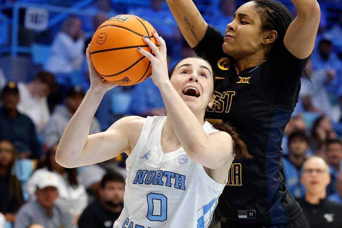 North Carolina’s Lanie Grant (0) heads to the basket while defended by West Virginia’s Sydney Shaw (5) during the first half of UNC’s game against West Virginia in the second round of the NCAA women’s basketball tournament at Carmichael Arena in Chapel Hill, N.C., Monday, March 24, 2025.
