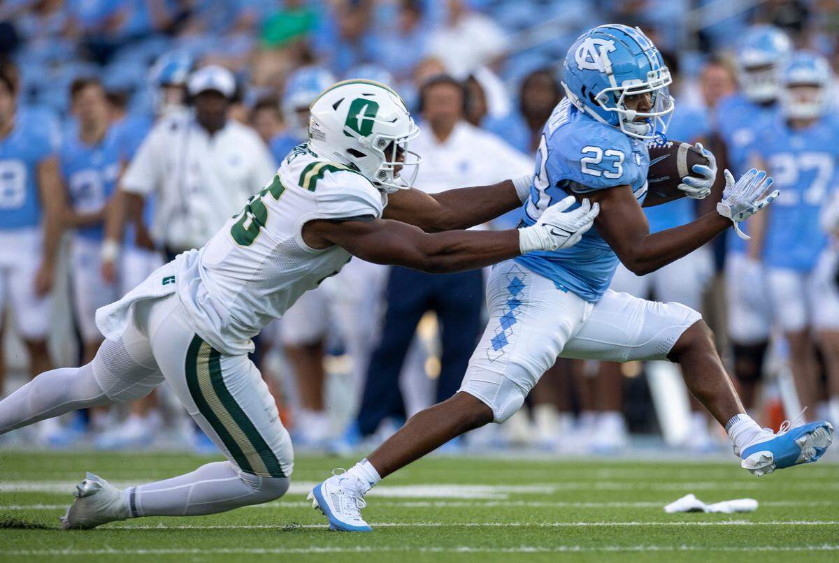 North Carolina running back Charleston French (23) breaks away from Charlotte linebacker Avery Morris (56) in the fourth quarter on Saturday, September 7, 2024 at Kenan Stadium in Chapel Hill, N.C.