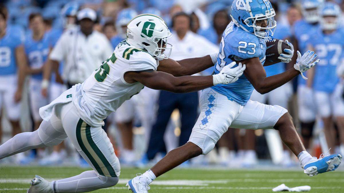 North Carolina running back Charleston French (23) breaks away from Charlotte linebacker Avery Morris (56) in the fourth quarter on Saturday, September 7, 2024 at Kenan Stadium in Chapel Hill, N.C.