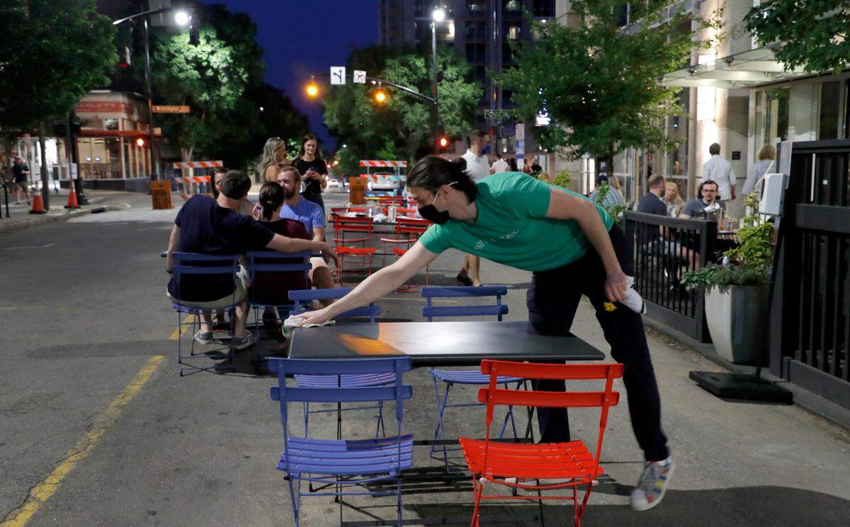 Lewis Norton of Bittersweet readies a table for new customers during Dine Out Downtown in Raleigh, N.C, Saturday evening, May 22, 2021.