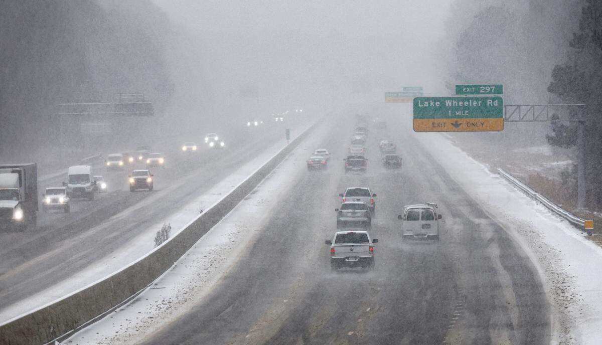 Heavy snow falls as cars travel on I-40 in Raleigh, as seen from Trailwood Drive looking east, Wednesday afternoon, Feb. 19, 2025.