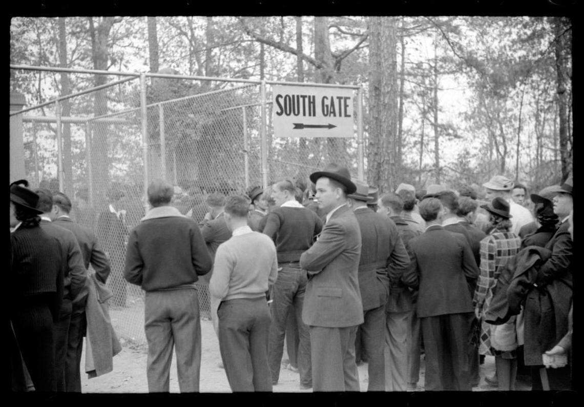 Fans who could not get tickets crowd outside a stadium gate in Durham, NC for the sold-out Duke-Carolina game in 1939.