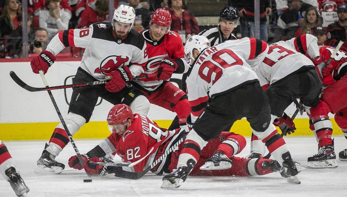 The Carolina Hurricanes Jesperi Kotkaniemi (82) hits the ice as he battles for the puck under New Jersey Devils Tomas Tatar (90) in the first period during Game 1 of their second round Stanley Cup playoff series on Wednesday, May 3, 2023 at PNC Arena in Raleigh, N.C.