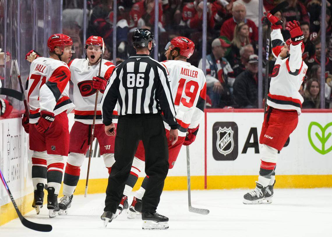Taylor Hall, left, of the Carolina Hurricanes celebrates his second-period goal against the Ottawa Senators with teammates Sebastian Aho and K'andre Miller in during Game 4 of the first round of the 2026 Stanley Cup Playoffs at Canadian Tire Centre on April 25, 2026 in Ottawa, Canada.
