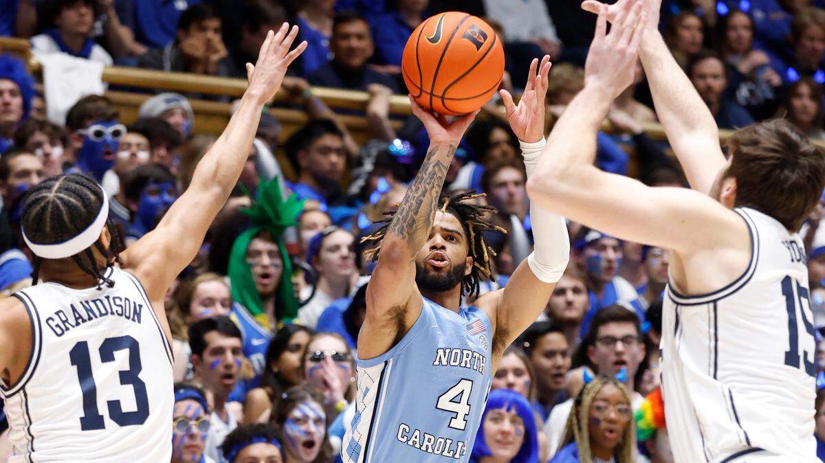North Carolina’s R.J. Davis (4) shoots as Duke’s Jacob Grandison (13) and Ryan Young (15) defend during the first half of Duke’s game against UNC at Cameron Indoor Stadium in Durham, N.C., Saturday, Feb. 4, 2023.