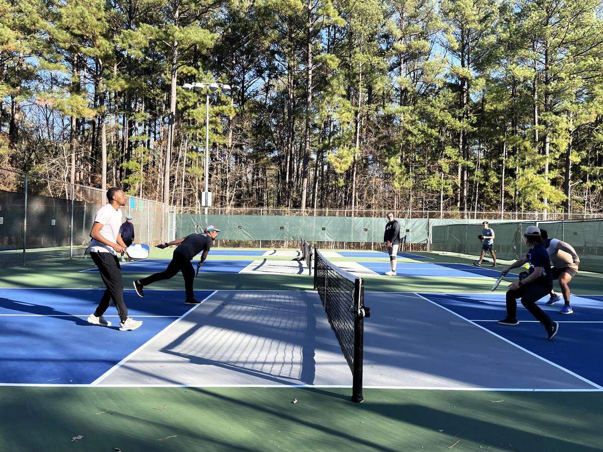 Timothy George and Tarun Prakash (at right) respond to a shot from David Truong and his partner Alex Nyairo during an afternoon pickleball game at Ephesus Park in Chapel Hill on Thursday, Dec. 7, 2023.