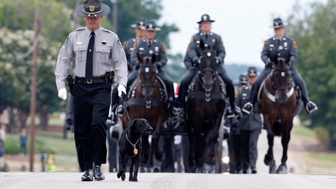 Slain Wake County Sheriffís Deputy Ned Byrdís K9 partner, Sasha, leads the N.C. State Highway Patrolís Caisson Unit during a procession for Deputy Byrd before his funeral at Providence Baptist Church in Raleigh, N.C., Friday, August 19, 2022.