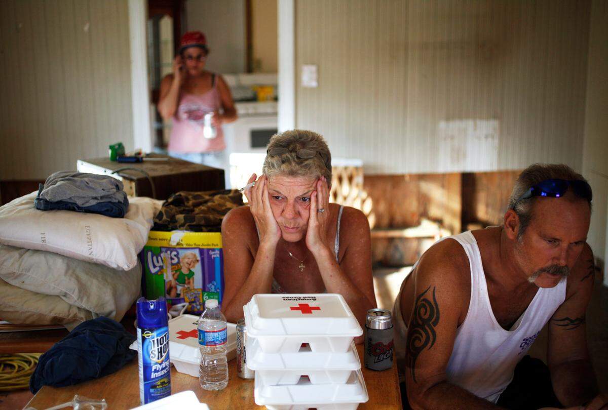 Sitting in Ivan and Pam Ireland’s house on September 8, 2011, neighbors Sue and Randy Caroon take a break from cleaning their own home almost two weeks after Hurricane Irene caused the Pamlico River to flood their town of Lowland. “We’re exhausted, confused, worried, heartbroken and uncertain,” Sue Caroon said. “We’re still waiting for answers (from insurance company) on what to do about our house. I want to start rebuilding but how far do I go?” Randy added.