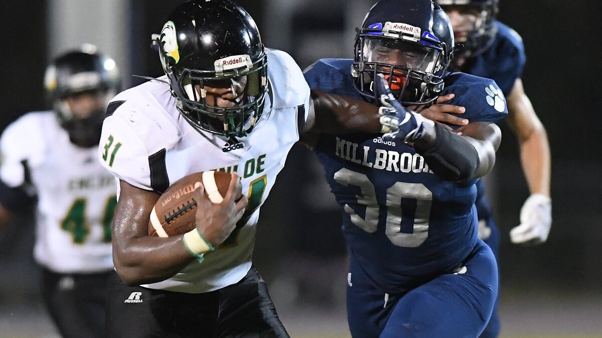 Christopher O’neal (31) of Enloe gains yards against Ka’leef Williams (30) of Millbrook. The Enloe Eagles visited the Millbrook Wildcats in a high school football game on September 28, 2018. Enloe won 21-14.
