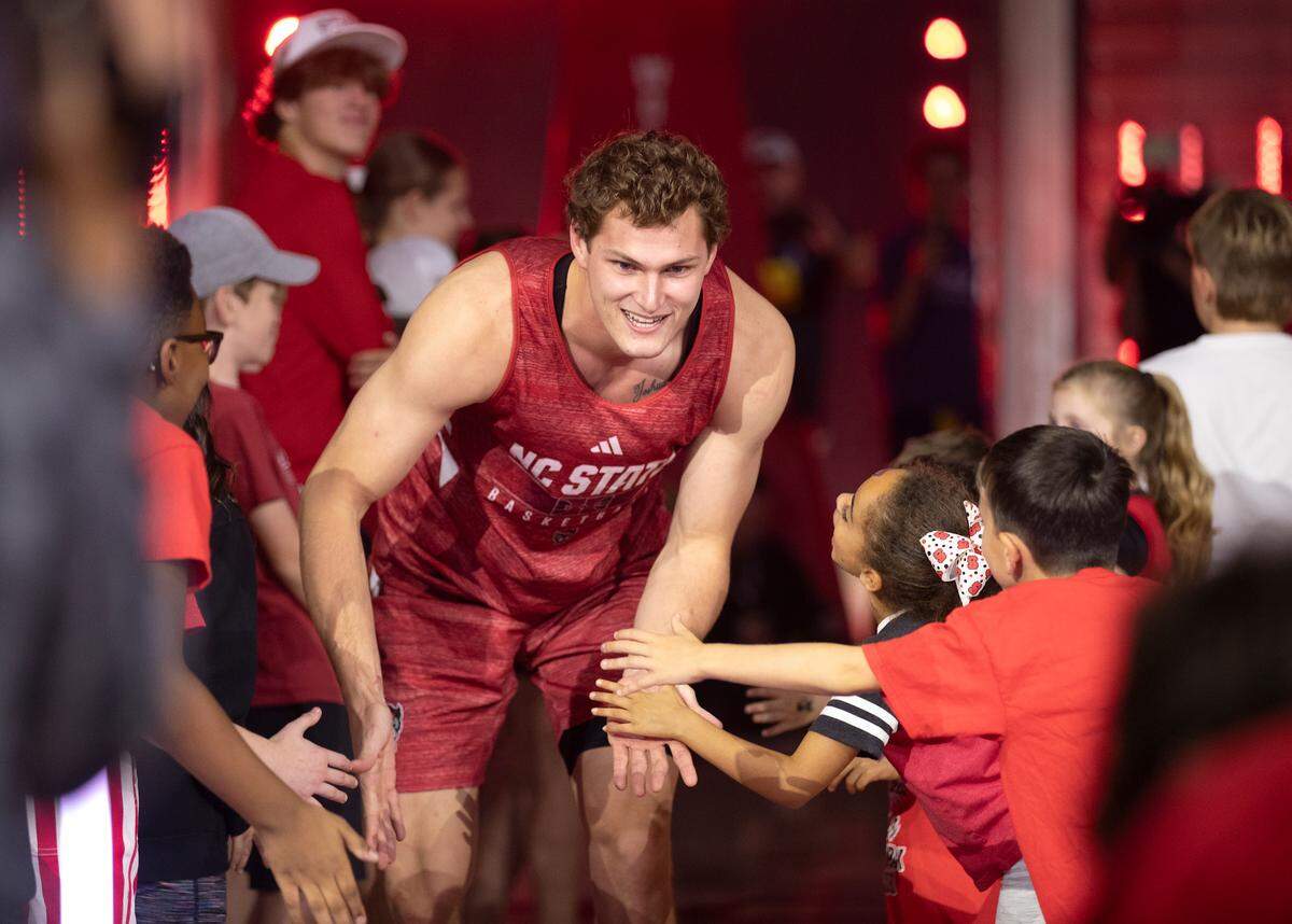 N.C. State’s Ben Middlebrooks receives high-fives from young fans after being introduced during the Primetime with the Pack preseason event on Friday, Oct. 25, 2024, at Reynolds Coliseum in Raleigh, N.C.
