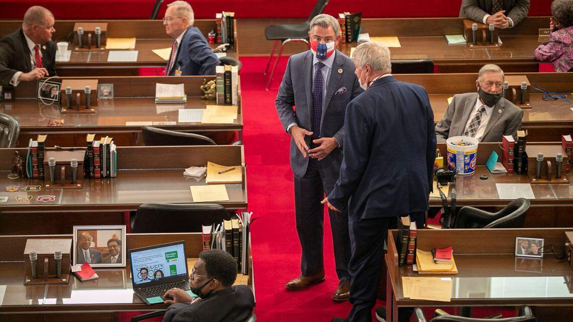 Senator Kirk deViere of Fayetteville talks with Rep. William Richardson of Fayetteville, N.C. on the House floor as they await Governor Roy Cooper’s arrival for the State of the State address on Monday, April 26, 2021 in Raleigh, N.C.