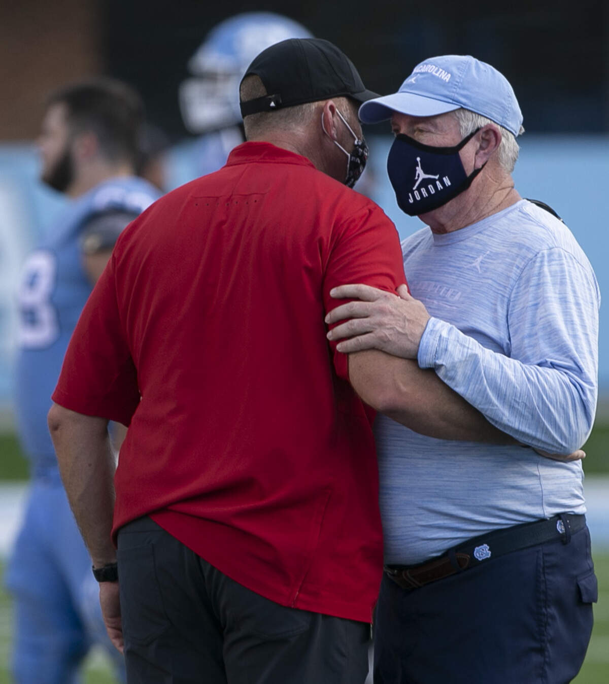 North Carolina coach Mack Brown embraces N.C. State coach Dave Doeren following the Tar Heels’ 48-21 victory at Kenan Stadium on Saturday, October 24, 2020 in Chapel Hill, N.C.
