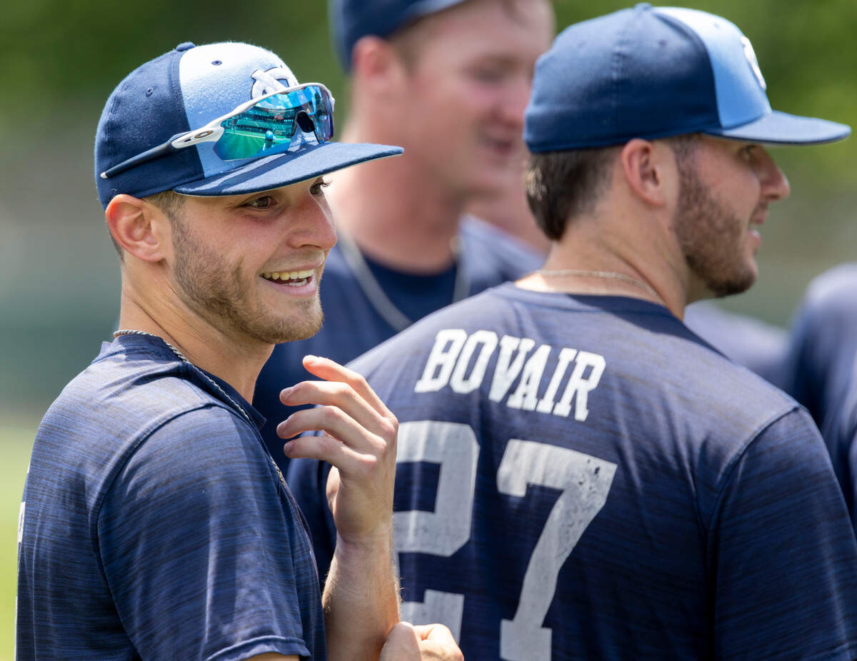 North Carolina’s Mikey Madej (2), left, and his teammates listen to coach Scott Forbes as he gives a scouting report on Arkansas at the conclusion of their practice on Friday, June 10, 2022 at Boshamer Stadium in Chapel Hill, N.C.