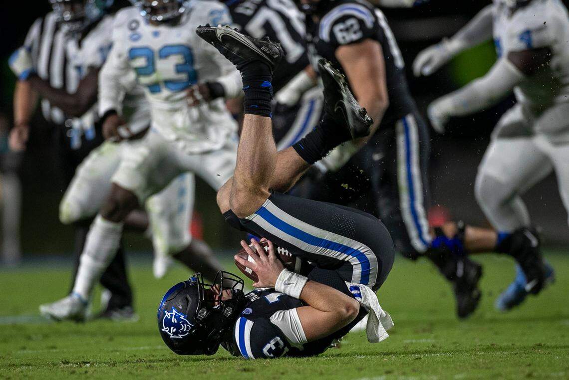 Duke quarterback Riley Leonard (13) is sacked by North Carolina’s DeAndre Boykins (16) in the second quarter on Saturday, October 15, 2022 at Wallace-Wade Stadium in Durham, N.C.