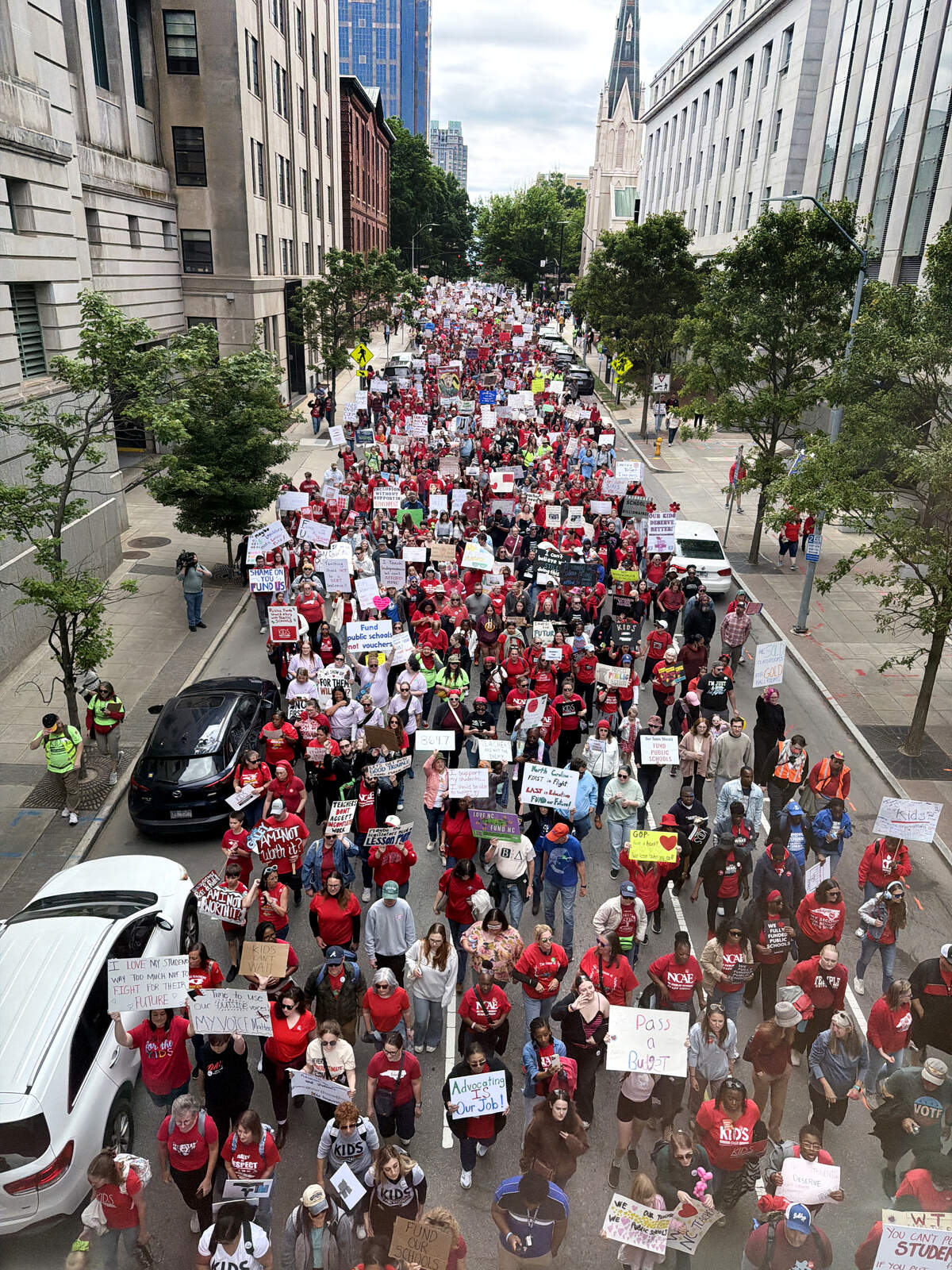 Protesters march through downtown Raleigh during a May Day rally for teachers and education, Friday, May 1, 2026.