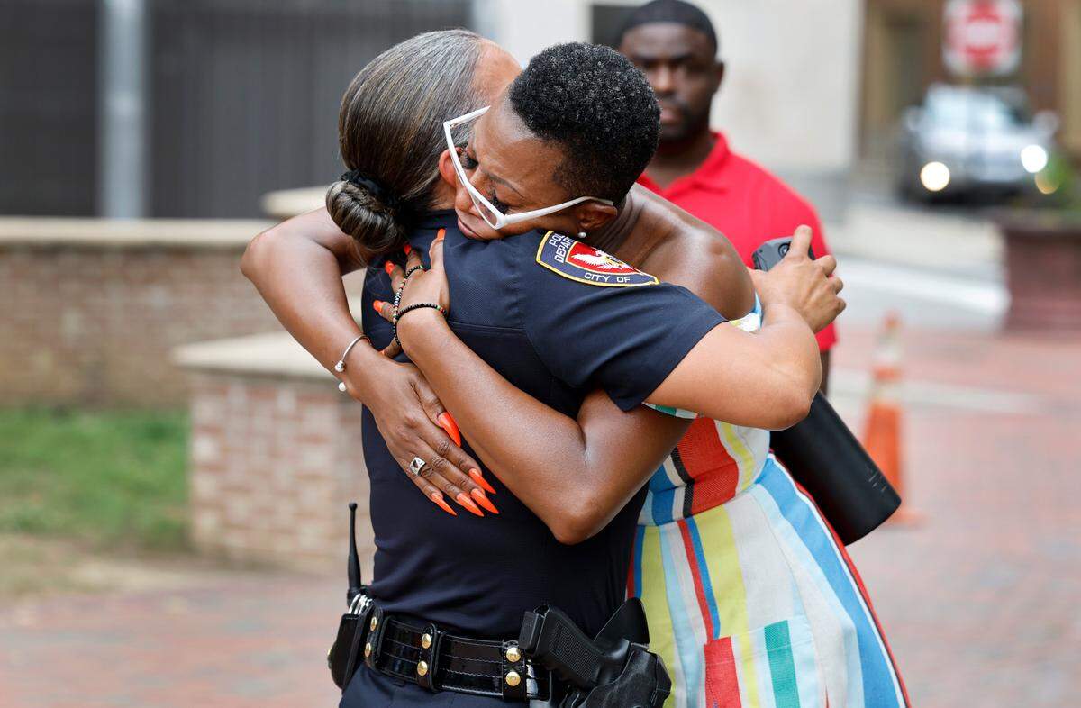 Durham Police Chief Patrice Andrews, left, and Shea Ramirez hug after a prayer vigil at CCB Plaza in Durham, N.C., Thursday, July 6, 2023. This week marked a grim milestone in Durham as gun violence claimed its youngest victim so far this year: 5-year-old Khloe Fennell. Khloe was one of two young people shot Wednesday afternoon. Ramirez, a local activist who organized Thursday’s event, said she felt called to host a community prayer event after she heard about Khloe’s death.