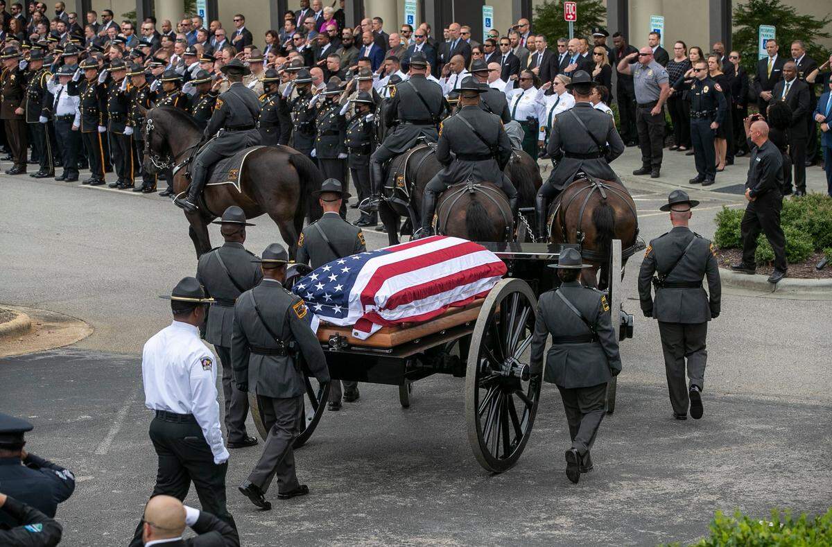 The North Carolina State Highway Patrols Caisson Unit carrying Wake County Deputy Ned Byrd’s casket arrives at Providence Baptist Church for his funeral in August 2022 in Raleigh.