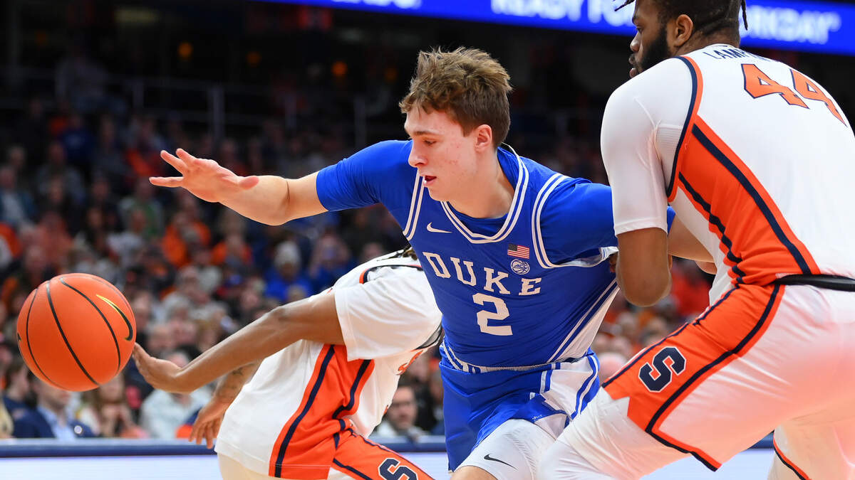 Duke Blue Devils guard Cooper Flagg (2) tries to keep control of the ball as Syracuse Orange center Eddie Lampkin Jr. (44) defends during the first half of their game at JMA Wireless Dome on Wednesday, Feb. 5, 2025.