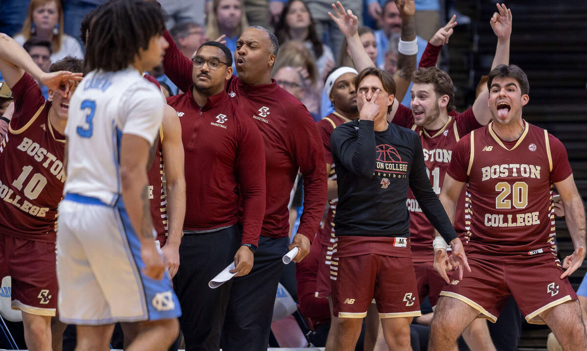 The Boston College bench erupts in celebration after a three point basket by Donald Hand Jr. to give the Eagles a four point lead late in the second half on Saturday, January 25, 2025 at the Smith Center in Chapel Hill, N.C.