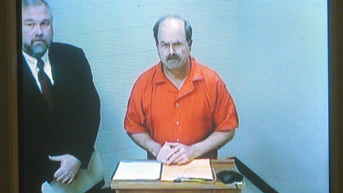 Serial murderer Dennis L. Rader, also known as the BTK Killer, in his first court appearance via video feed from the Sedgwick County Jail Tuesday, March 1, 2005, in Wichita, Kansas. His attorney, Richard Ney, is at left.