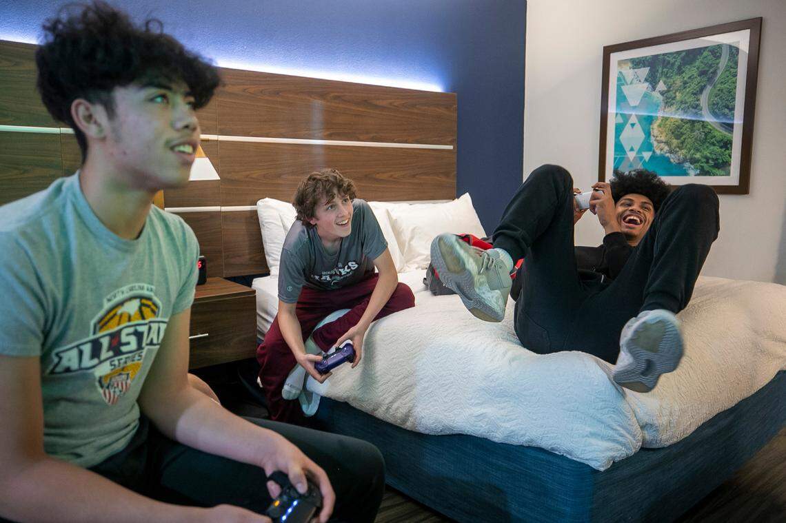 Jarin Stevenson reacts after winning a soccer video game with Seaforth High School teammates Darren Moore and Brandon Sturdivant in the team hotel during the Carolina’s Challenge Showcase tournament on Tuesday, December 27, 2023 in Lexington, South Carolina.