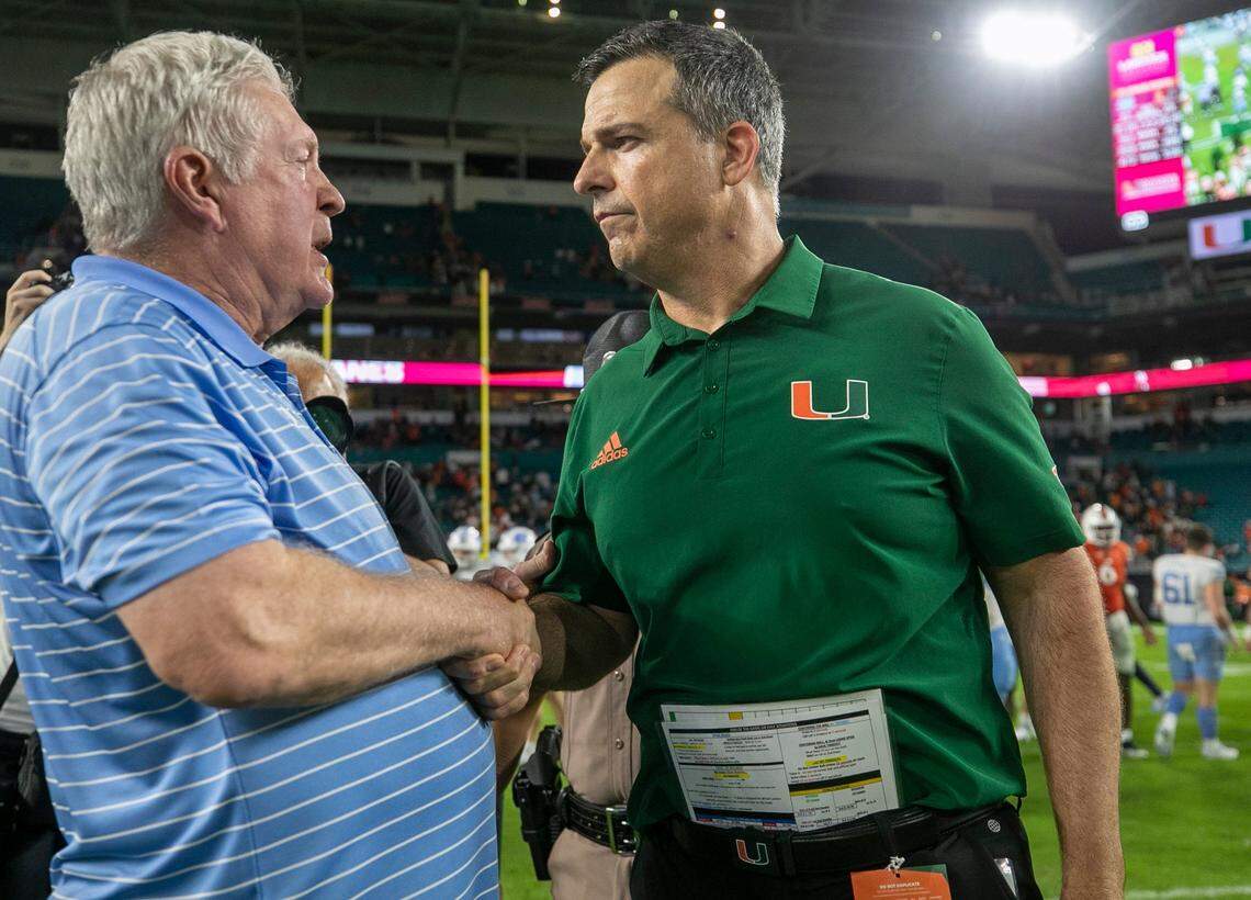 Miami coach Mario Cristobal congratulates North Carolina coach Mack Brown following the Tar Heels’ 27-24 victory on Saturday, October 8, 2022 at Hard Rock Stadium in Miami Gardens, Florida.